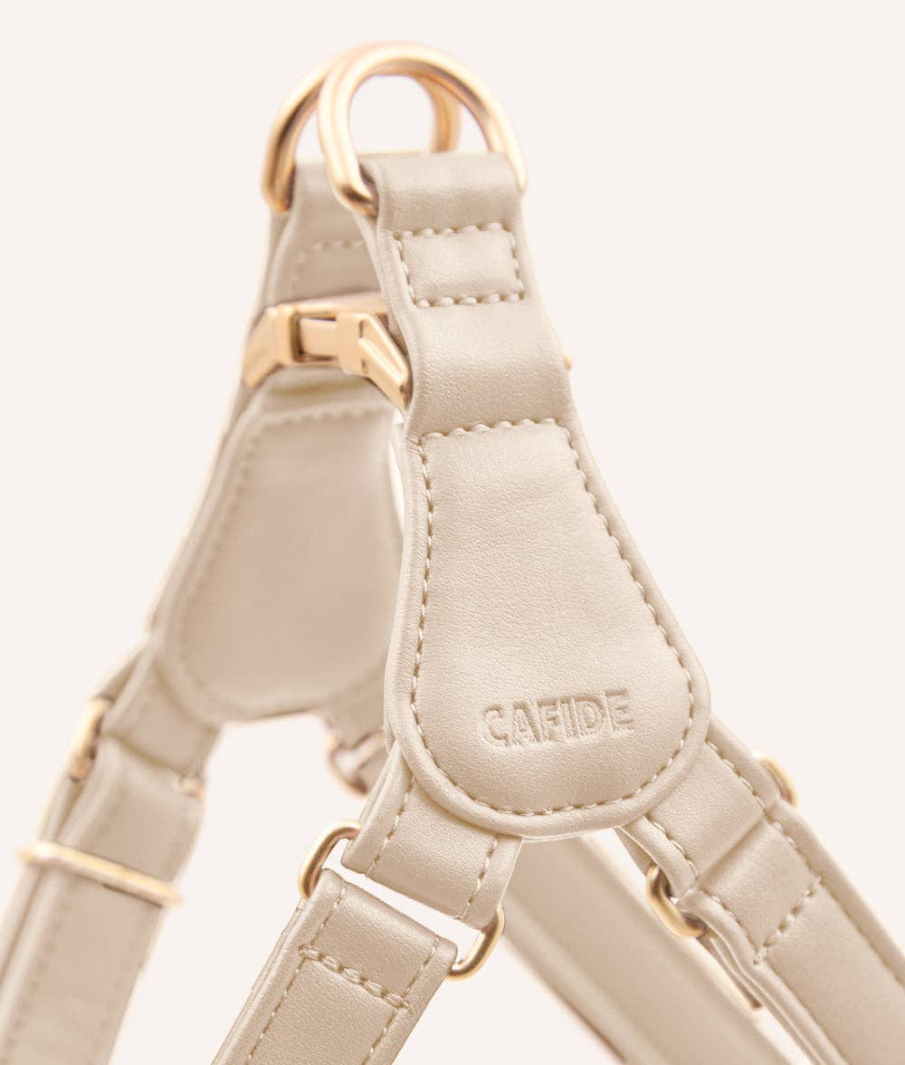 Close-up of ivory vegan leather dog harness showing stitching and adjustable buckle
