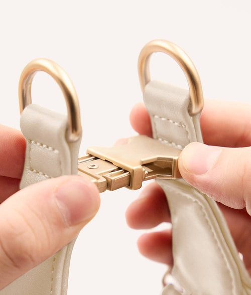 Close-up of ivory vegan leather dog harness showing stitching and adjustable buckle